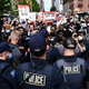 Black Lives Matter protesters are stopped by police at the entrance to a rally that US President Donald Trump will hold later in the evening at the BOK Center on June 20, 2020, in Tulsa, Oklahoma. - Hundreds of supporters lined up early for Donald Trump’s first political rally in months, saying the risk of contracting COVID-19 in a big, packed arena would not keep them from hearing the president’s campaign message.